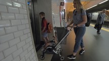 Family using lift at subway station