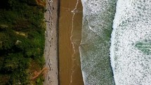 tide washing onto a shore - aerial view 