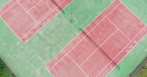 Empty Tennis Courts At Daytime. - aerial descend