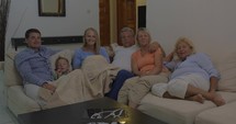 Big family watching TV in the evening
