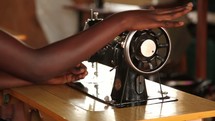 a woman on a sewing machine in Uganda 
