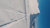 Vertical video of frozen snowy alps mountains in beautiful sunny day with blue sky, Social media story of winter ski touring adventure
