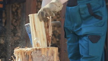 man with an ax chopping wood 