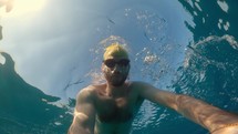 Free diving swimmer uses an underwater camera