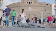 Rome, Italy - November 2022: Statue artwork at bridge Ponte Sant Angelo over the Tiber river Rome, Italy. Tourist walking byb statue