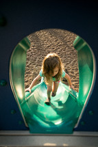 Girl climbing playground slide