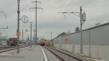 Train arrives at railway station. Swiss – circa 2012.