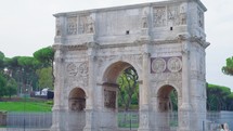 Arch of Constantine on background of blue sky on sunny day, located between coliseum and Arch of Titus on Roman road, built to celebrate triumph of
