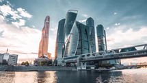 moscow city skyscrapers by the river with futuristic architecture at sunset 4K drone shot