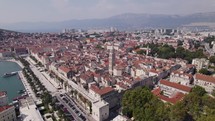Aerial panorama of Split, showcasing old town charm, mountains, and urban life