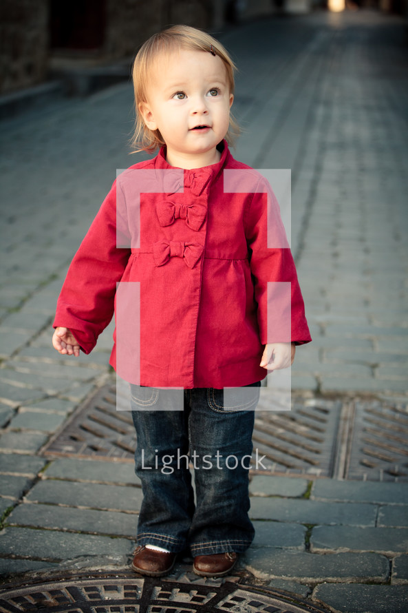 toddler girl wearing a red peacoat
