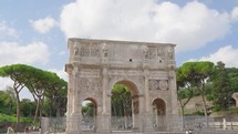 Arch of Constantine on background of blue sky on sunny day, located between coliseum and Arch of Titus on Roman road, built to celebrate triumph of
