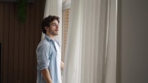Peaceful man at the window breath fresh air feels calm. Anxiety relief, brings internal state in order exercise. No stress, mindfulness concept
