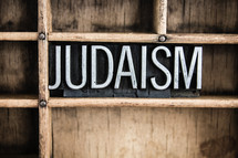 word Judaism in blocks on a bookshelf 