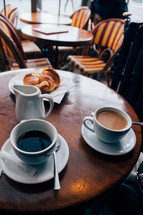 coffee and croissants on a table in a cafe 