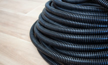 Black corrugated pipe for the cable. It is used for electrical installations.