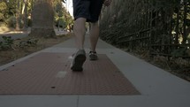 man running on a sidewalk 