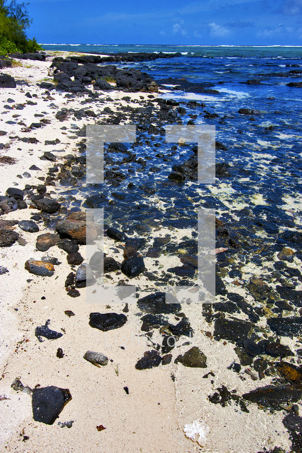 rocks on a sandy shore in blur bay 