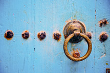 rusty door pull and blue door