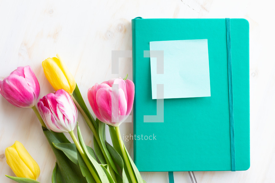 blank note, journal, and tulips 