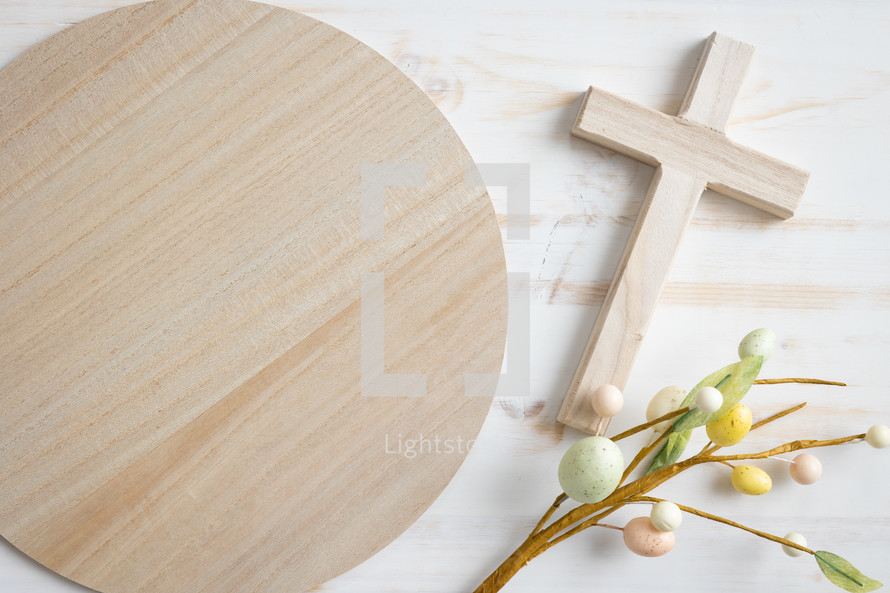 Small wood cross, easter eggs and round wood copy space