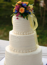 flowers on the top of a wedding cake 