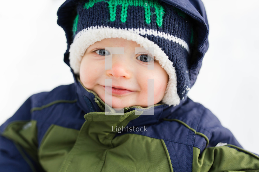 toddler boy in a snowsuit 