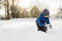 child making a snowball 