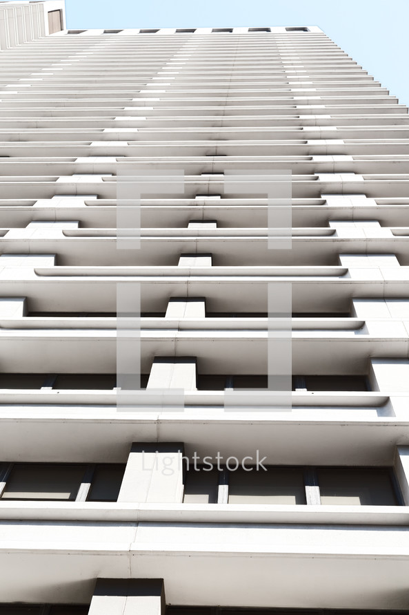 looking up to the top of a building with terraces 