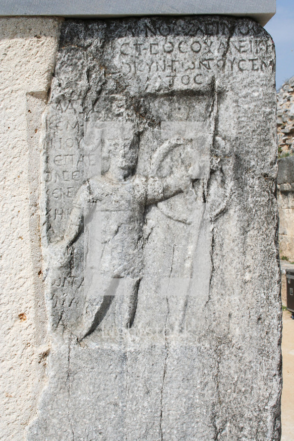 The stone engraving depicts a gladiator at the gate. This historic theater in Philippi would have been visited by the Apostle Paul, Silas, Lydia and early Christians from Acts 16. The theater would have housed dramas and gladiator fights.