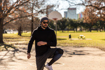 A man exercising in a park.