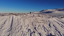 walking on top of a snow covered mountain 