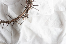 Crown of thorns on white linen 