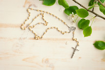 Rosary and branch with white blossoms