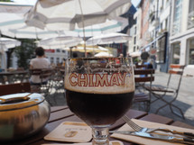 CHIMAY, BELGIUM - CIRCA AUGUST 2019: Chimay beer, selective focus on glass