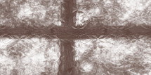rough brown cross behind patterned glass 