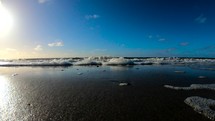 Waves crashing on the shore of the beach in Langeoog, Germany