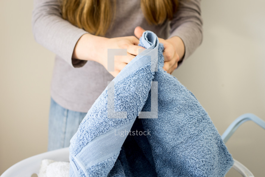 Girl folding the Laundry