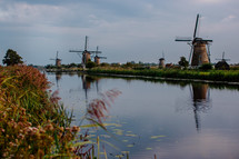 Windmills along a river in Europe.