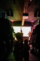 children playing in the aisle during a worship service 