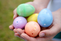 cupped hands with Easter eggs 