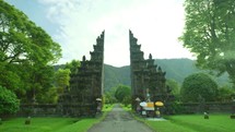 Bali split gate indonesia hindu temple architecture lush green landscape cultural landmark travel tourism spiritual nature scenic peaceful serene 4k
