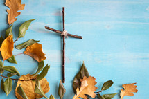 simple cross of sticks and fall leaves 