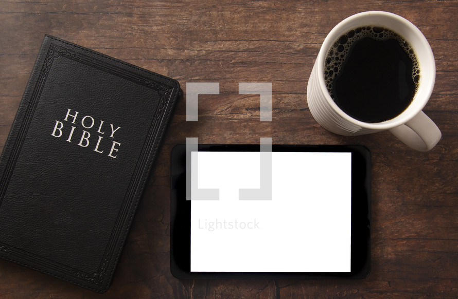tablet, Bible and coffee cup on a wood background