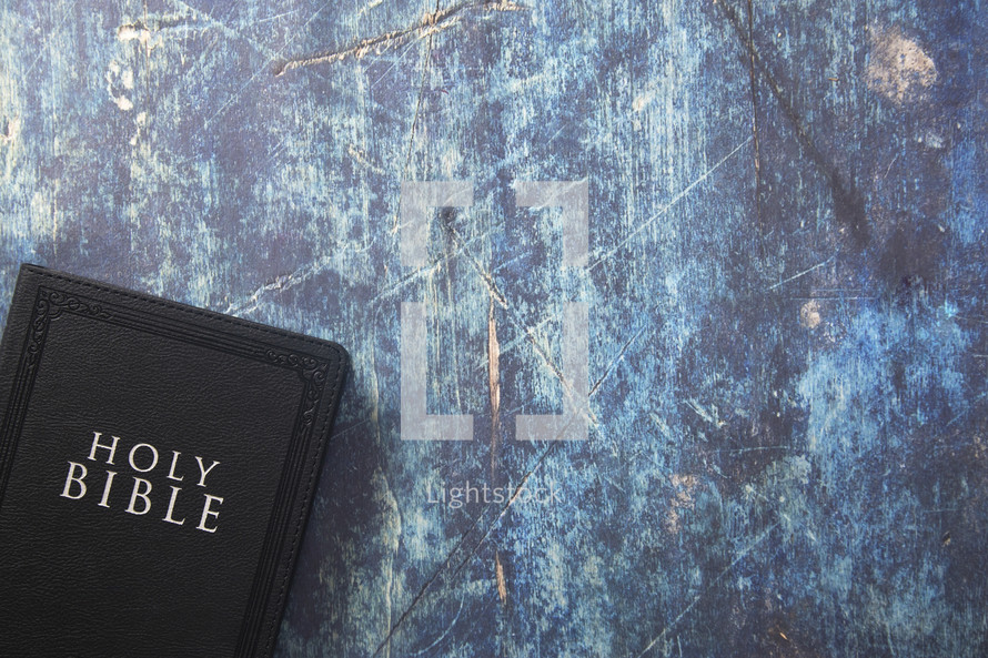 Bible on a blue grunge background 