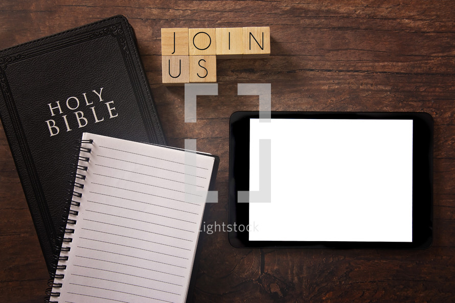 Bible and notebook on a wood background - join us 