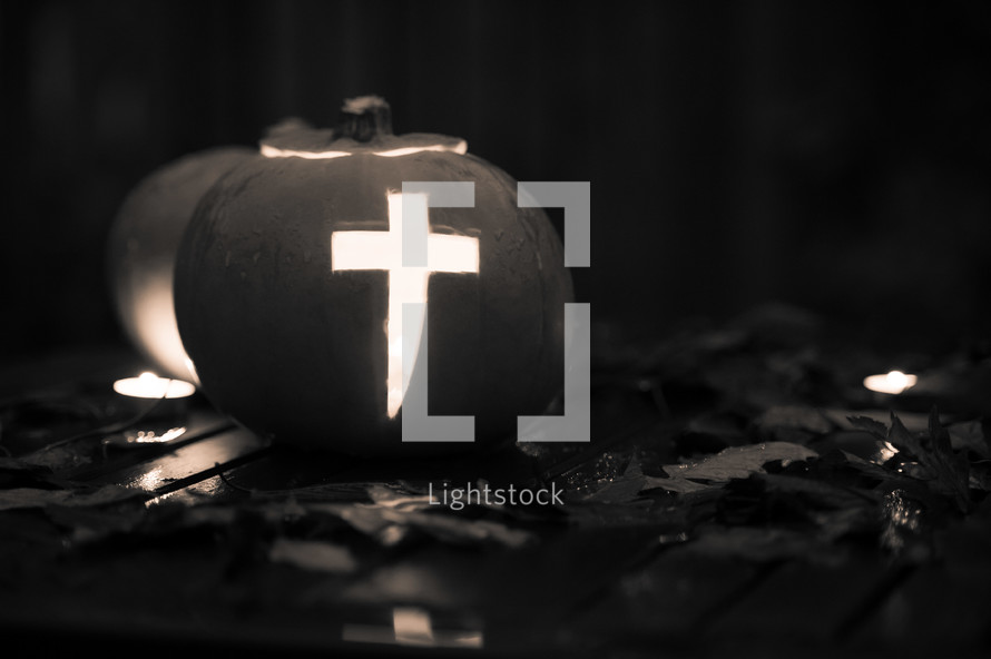 Pumpkin with a cross carved into it