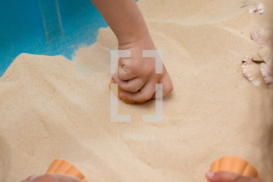 child playing in the sand 