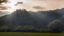 Medieval citadel at sunset with rays
