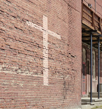 cross on an old brick wall 